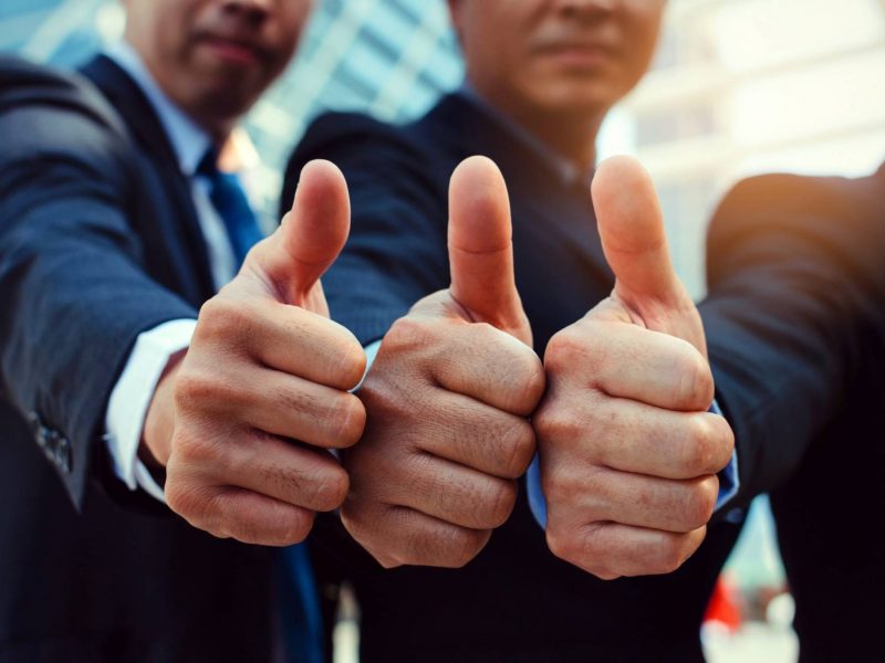 Great. close up of hand group of handsome business people team in suit showing thumbs up as like sign together in city, successful, support, meeting, partner, teamwork, community, connection concept
